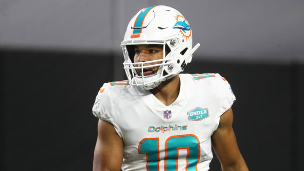 Dolphins wide receiver Malcolm Perry warms up before a game.